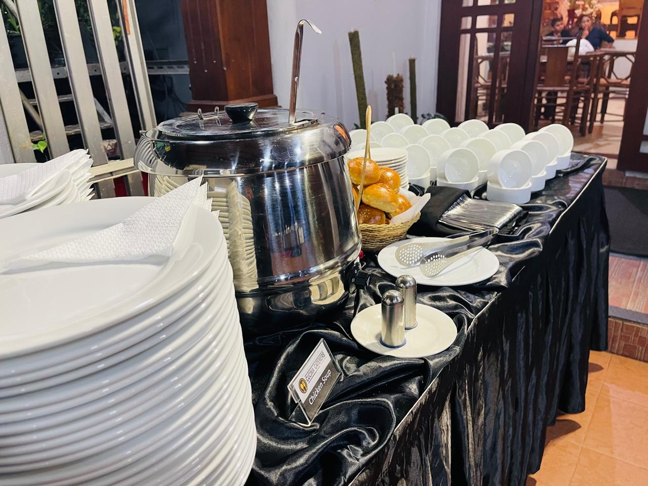Chicken soup station with fresh bread rolls