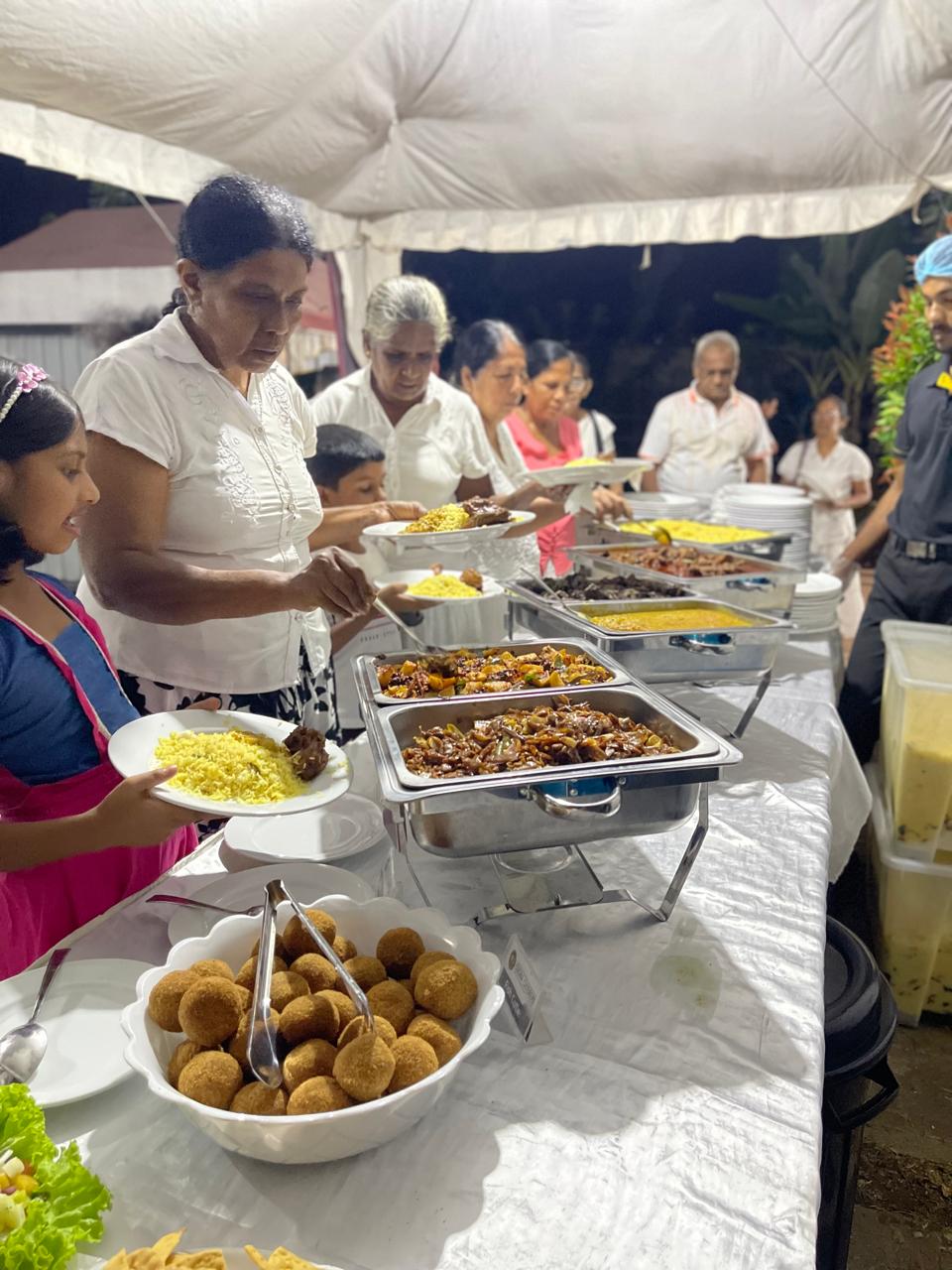 Guests being served at a catered buffet